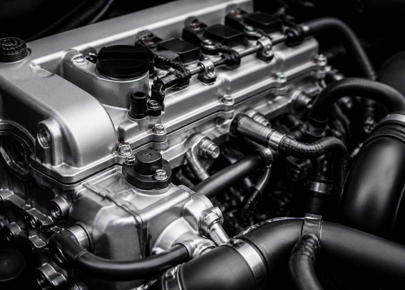 Close-up of an engine bay with cylinder head and hoses
